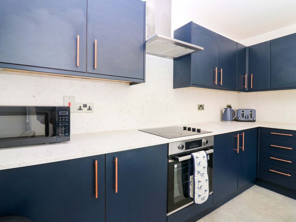 A kitchen with a microwave and oven at No.9 North St, Fraserborough