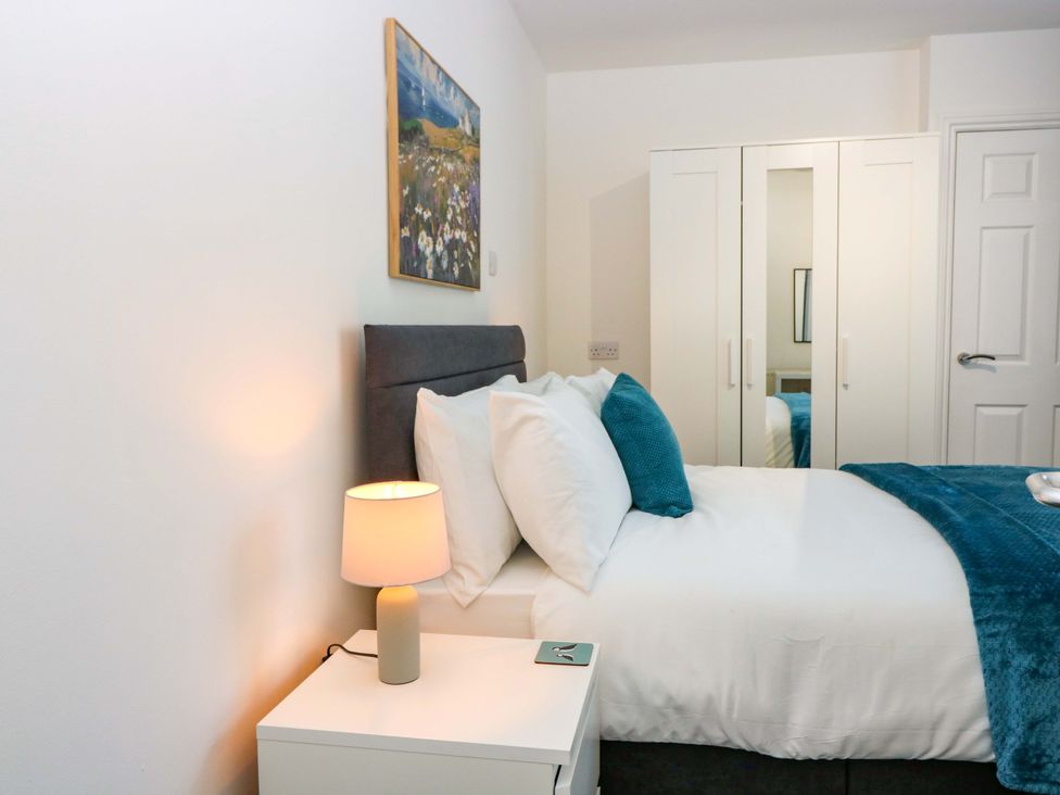 A bedroom with a bed and a wardrobe at No.9 North St in Fraserborough
