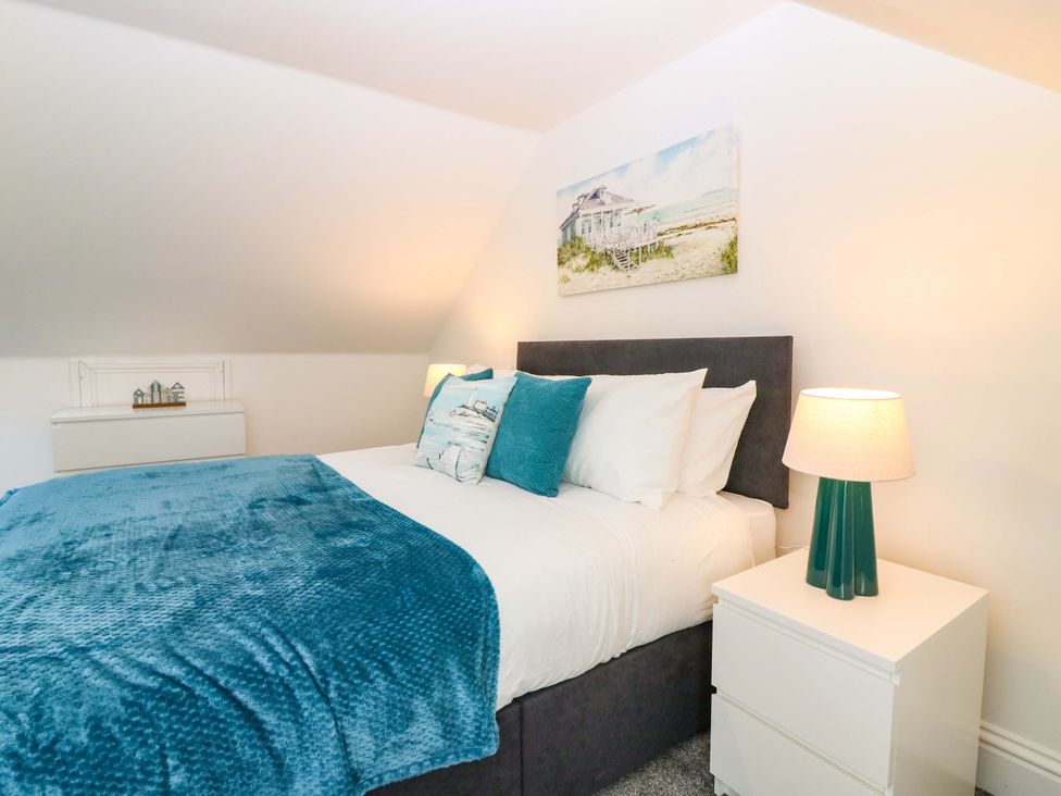 A bedroom with a bed and bedside table at No.9 North St in Fraserburgh