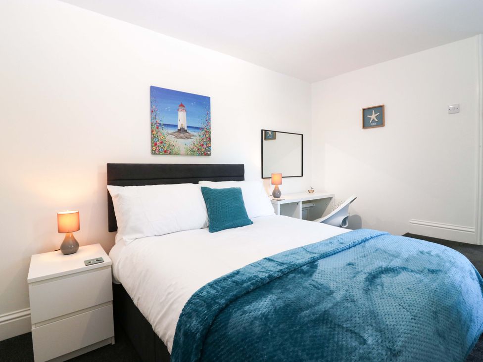 A bedroom with a bed and nightstand at No.9 North St Fraserborough