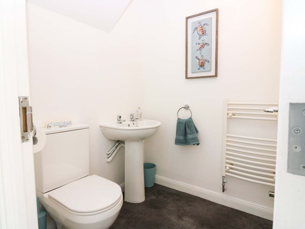 A bathroom with a toilet and sink at No.9 North St Fraserborough