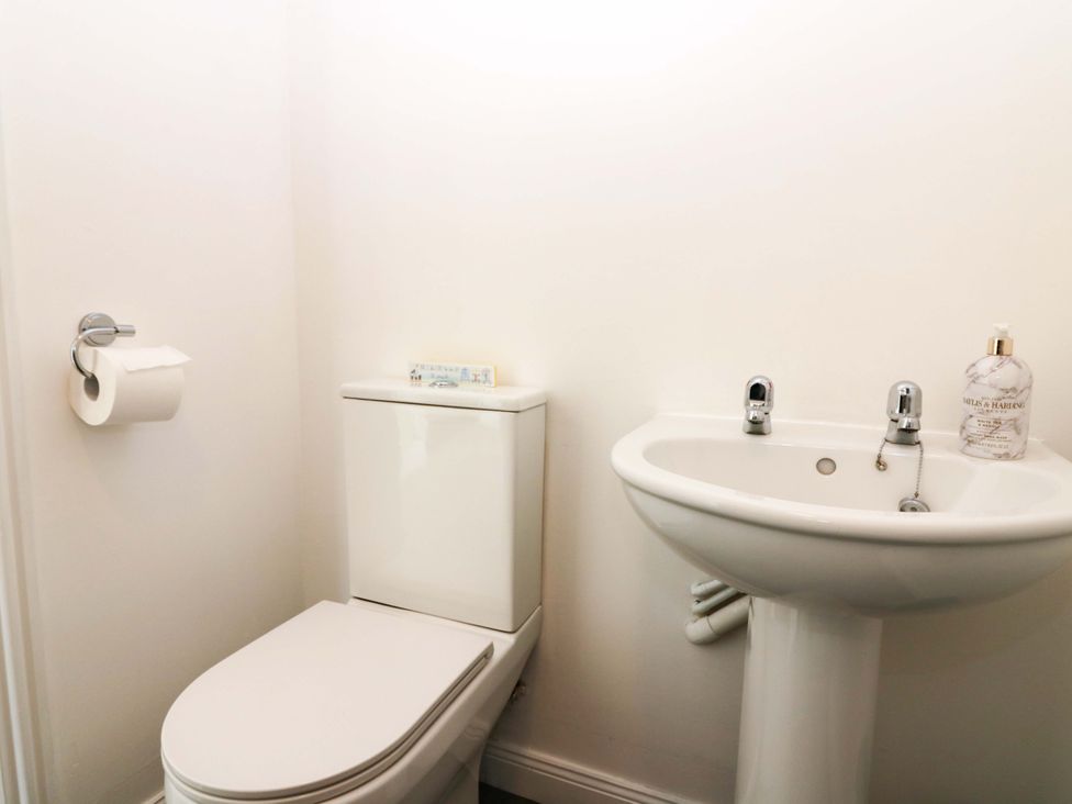 A bathroom with a toilet and sink at No.9 North St Fraserborough