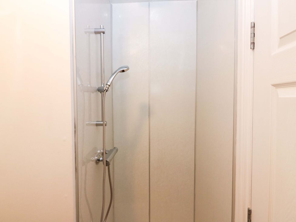 A shower with a shower head and panel at No.9 North St Fraserborough