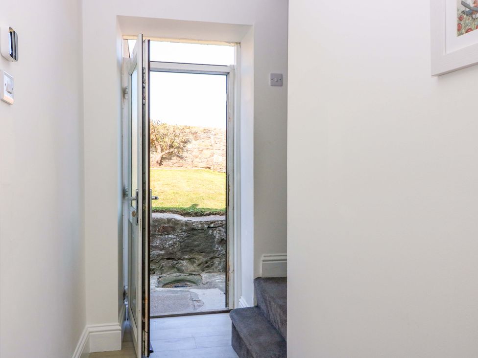 A hallway with a door leading outside at No.9 North St in Fraserborough