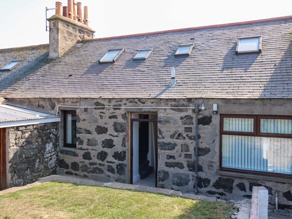 An outdoor view of a stone building with a roof and stairs at No.9 North St Fraserborough