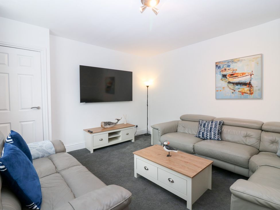 A living room with a television and a coffee table at No.9 North St Fraserburgh