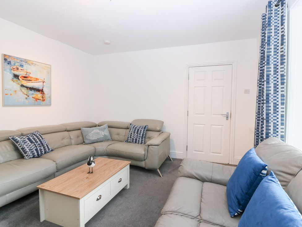 A living room with a sofa and coffee table at No.9 North St in Fraserburgh