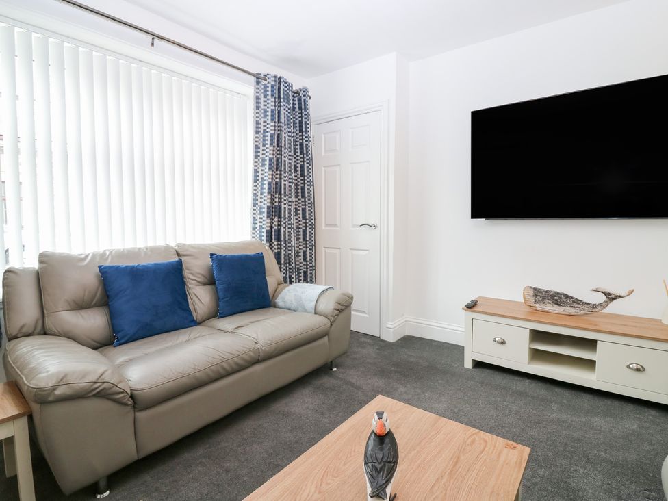 A living room with a sofa and television at No.9 North St in Fraserburgh