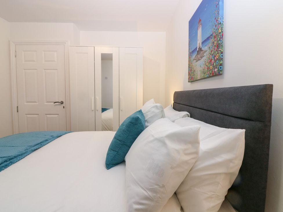 A bedroom with a bed and wardrobe at No.9 North St in Fraserburgh
