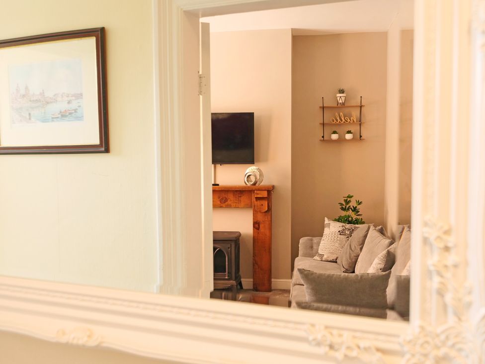 A living room with a television and a sofa at Ashville Grange in Scarborough
