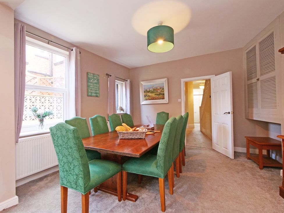 A dining room with a table and chairs at Ashville Grange in Scarborough