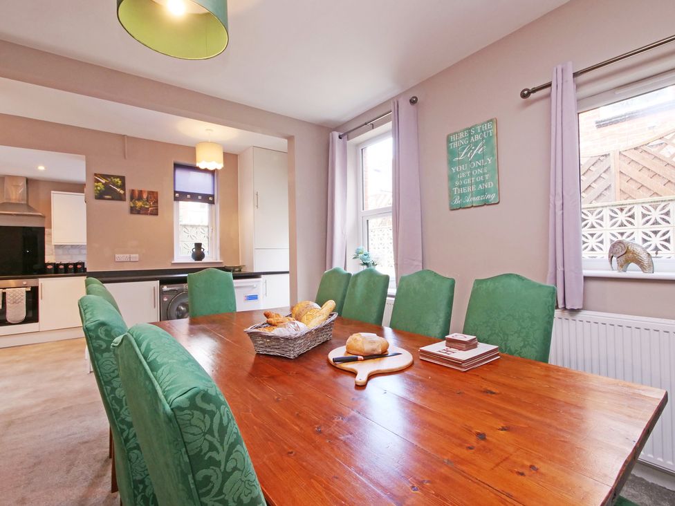 A dining room with a table and chairs at Ashville Grange in Scarborough