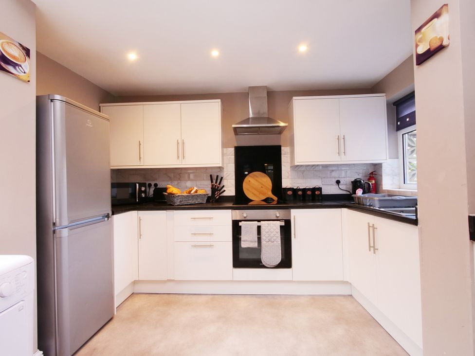 A kitchen with appliances and cabinets at Ashville Grange in Scarborough