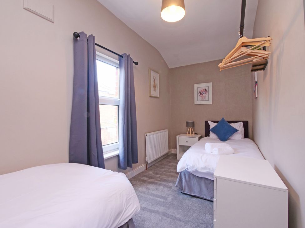 A bedroom with two beds and a window at Ashville Grange in Scarborough