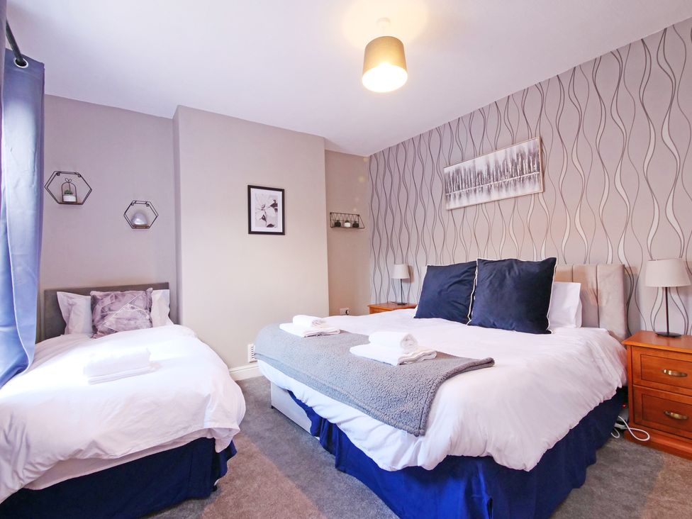 A bedroom with two beds and nightstands at Ashville Grange in Scarborough