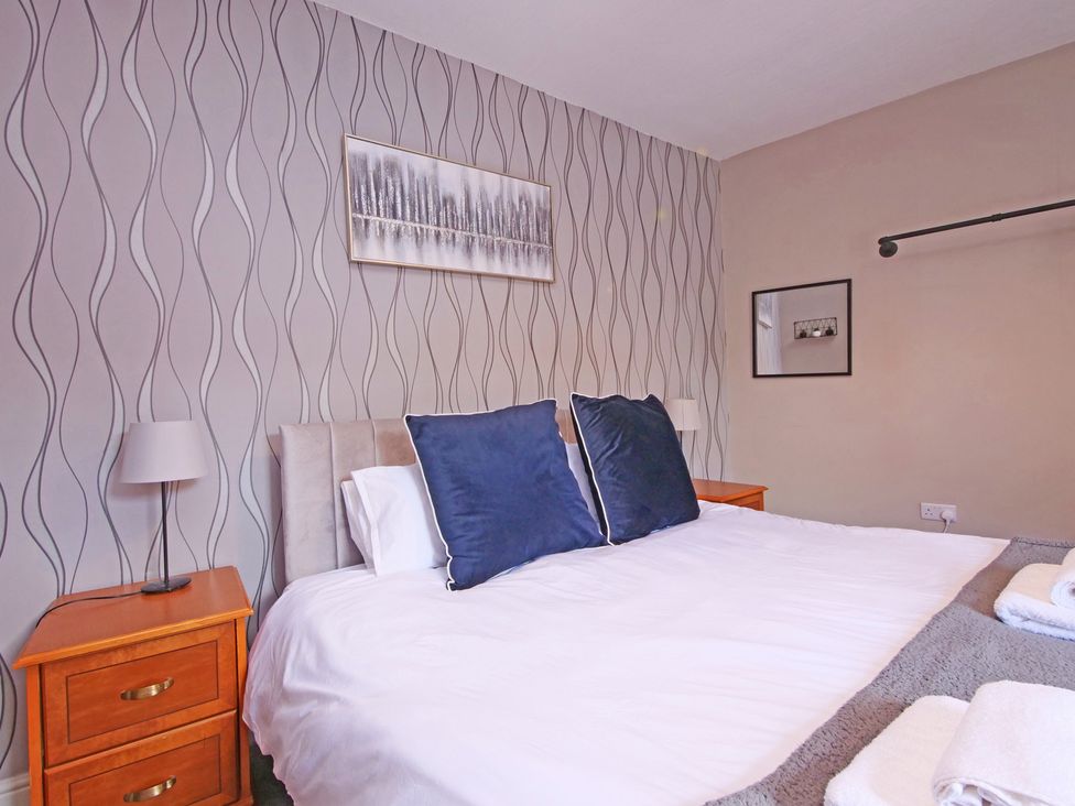 A bedroom with a bed and bedside table at Ashville Grange in Scarborough