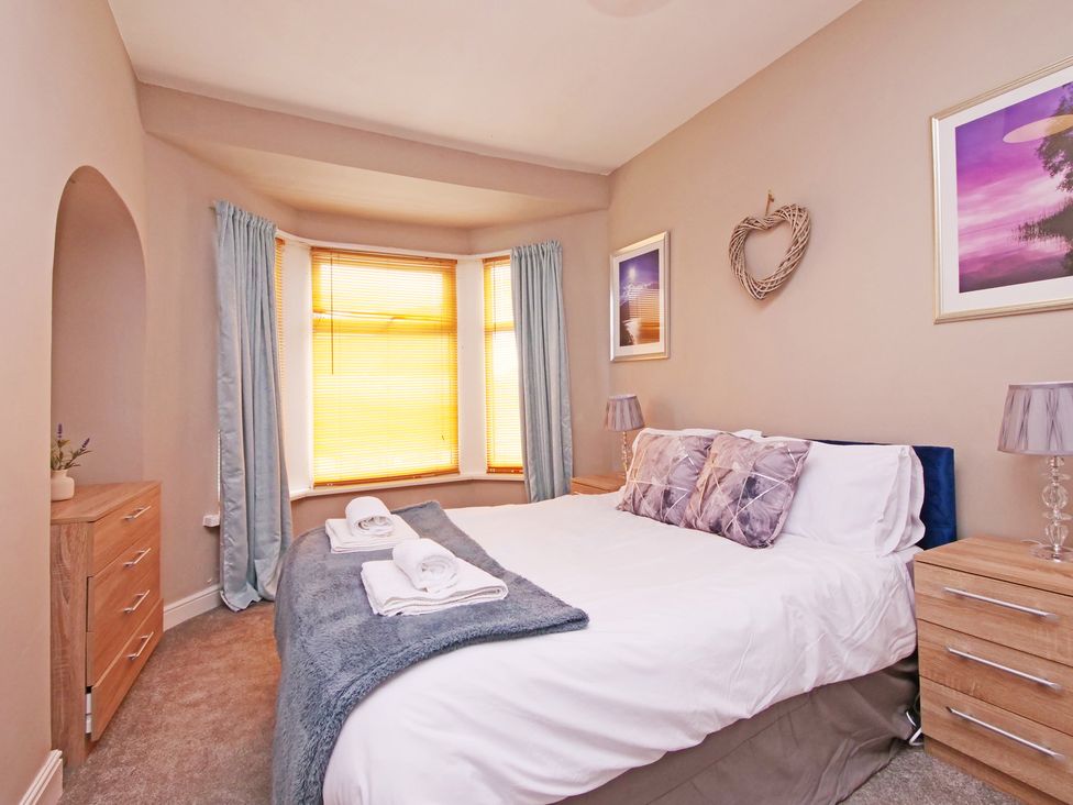 A bedroom with a bed and dresser at Ashville Grange in Scarborough