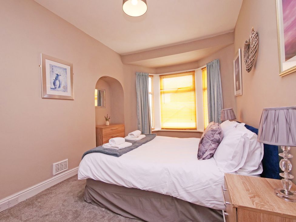 A bedroom with a bed and nightstand at Ashville Grange in Scarborough