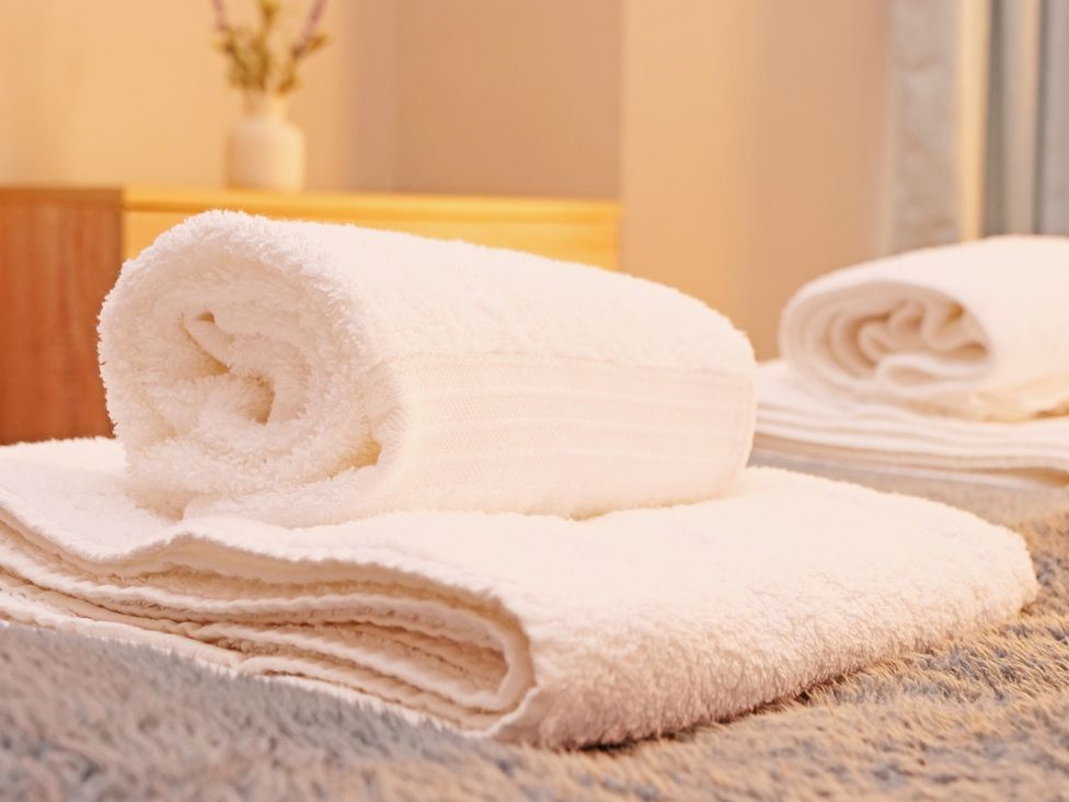 A set of rolled towels on a surface at Ashville Grange in Scarborough