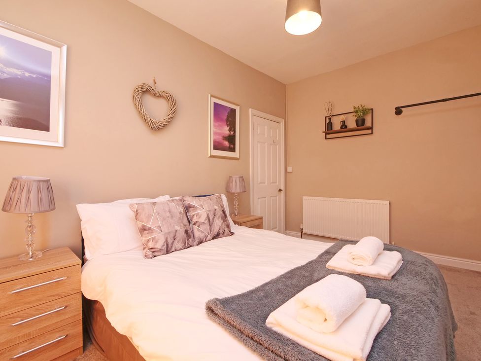 A bedroom with a bed and bedside tables at Ashville Grange in Scarborough