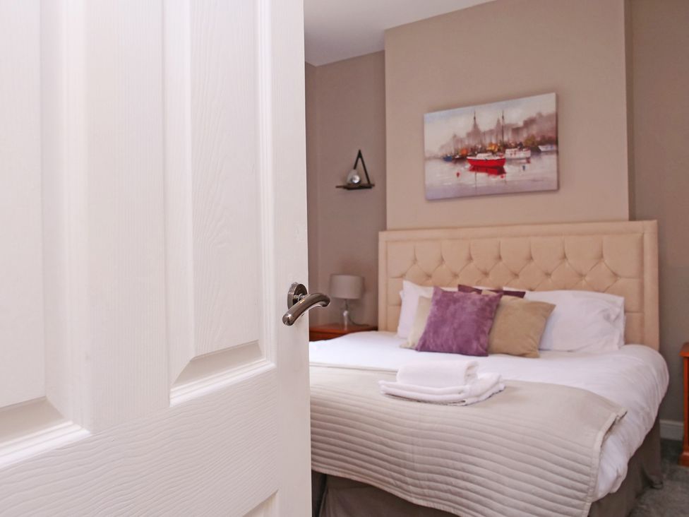 A bedroom with a bed and bedside table at Ashville Grange in Scarborough