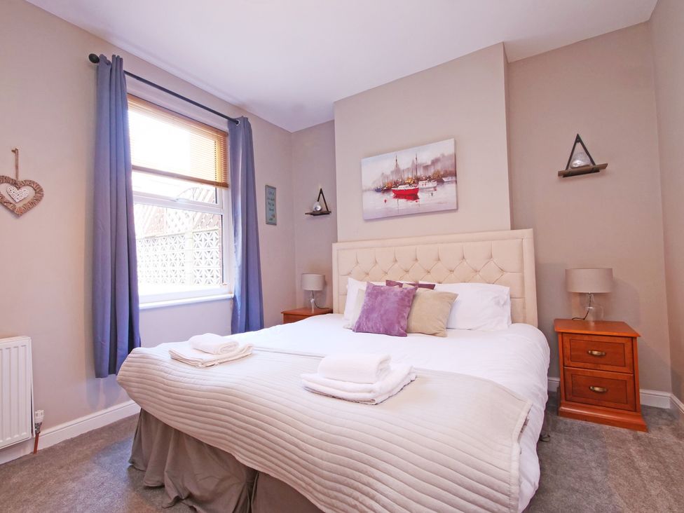 A bedroom with a bed and nightstand at Ashville Grange in Scarborough