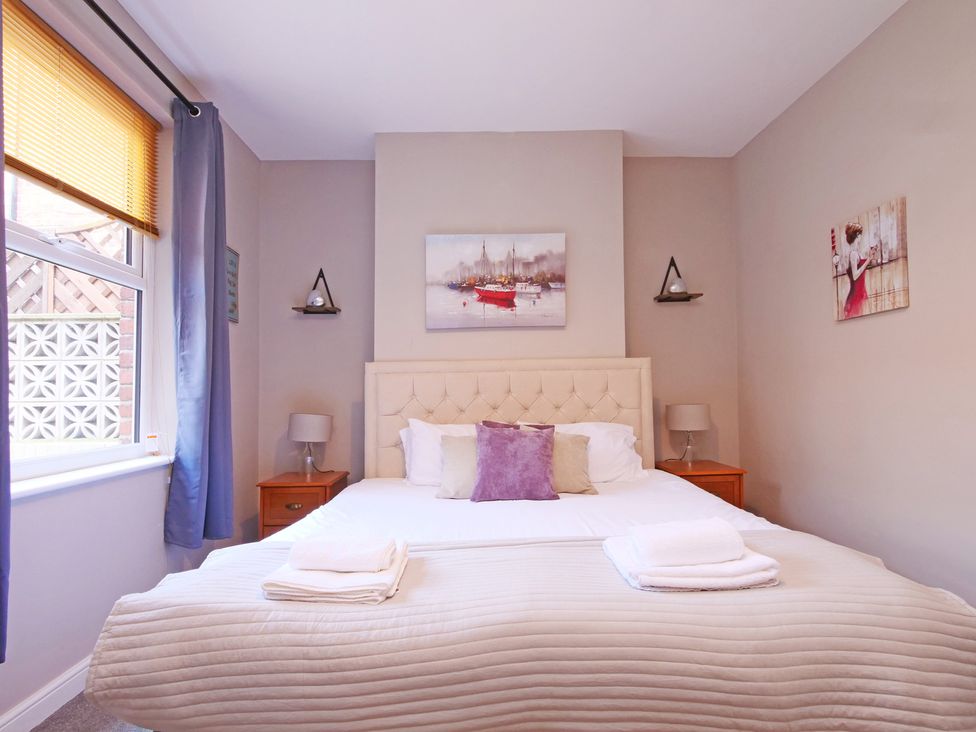 A bedroom with a bed and bedside tables at Ashville Grange in Scarborough