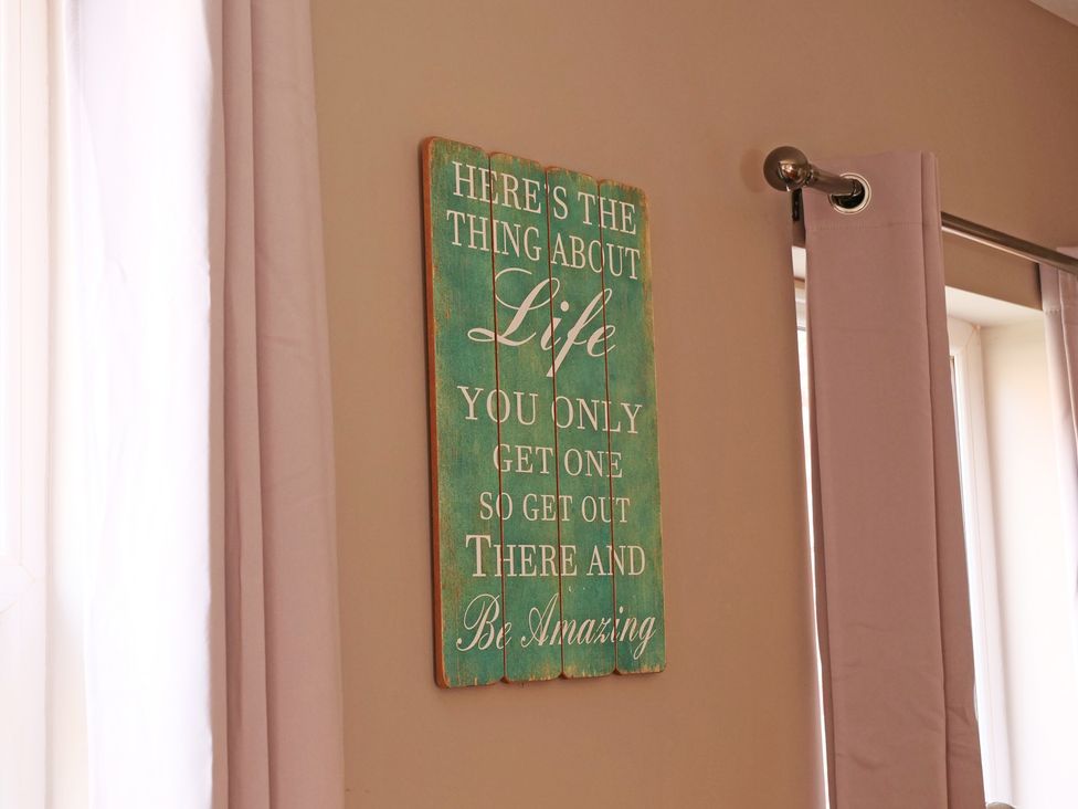 A wall sign with text in a living room at Ashville Grange Scarborough