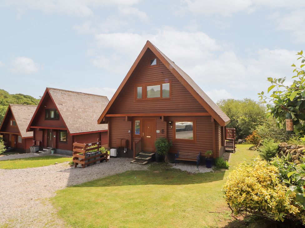 A cabin with a front door and garden at Thistle Dubh ('Doo') in Sandyhills
