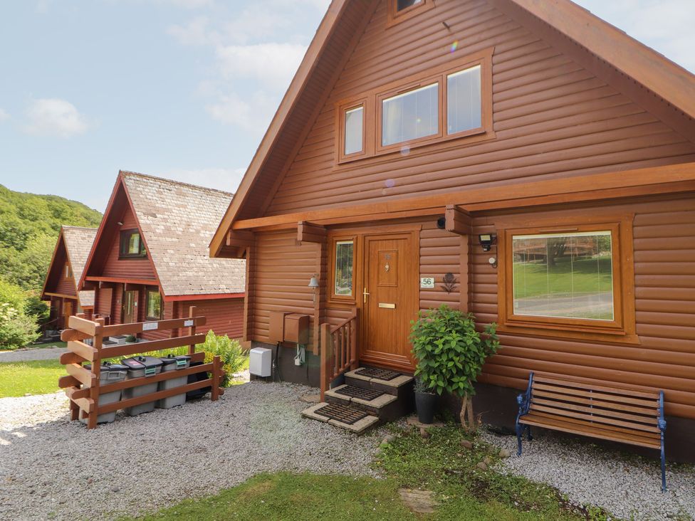 A log cabin exterior with door and windows at Thistle Dubh ('Doo') Sandyhills