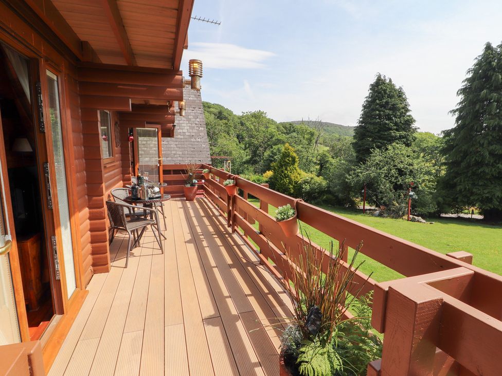 A deck with table and chairs at Thistle Dubh ('Doo') Sandyhills