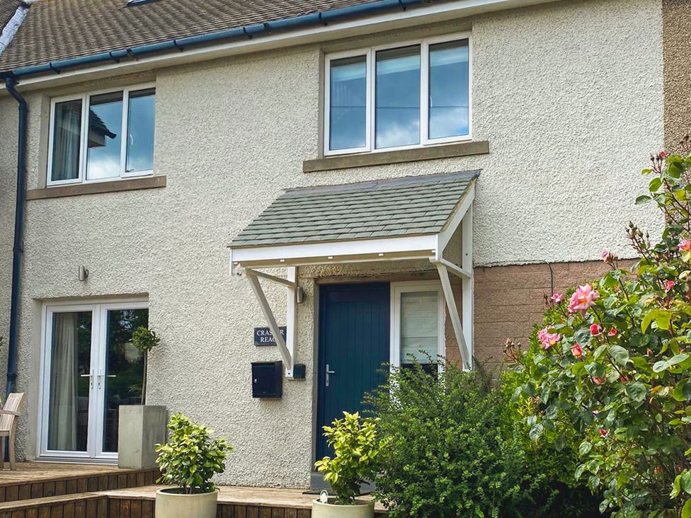 A house exterior with a porch and plants at Craster Reach in Craster