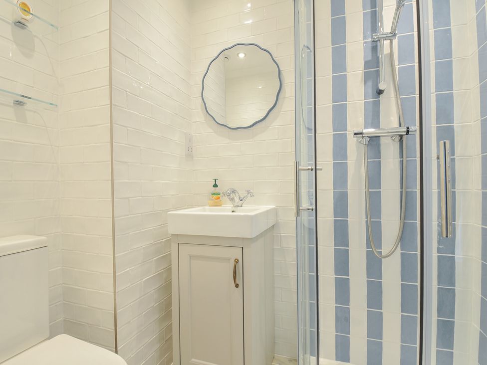 A bathroom with a sink and shower at 6 Trelawney Court in Rock