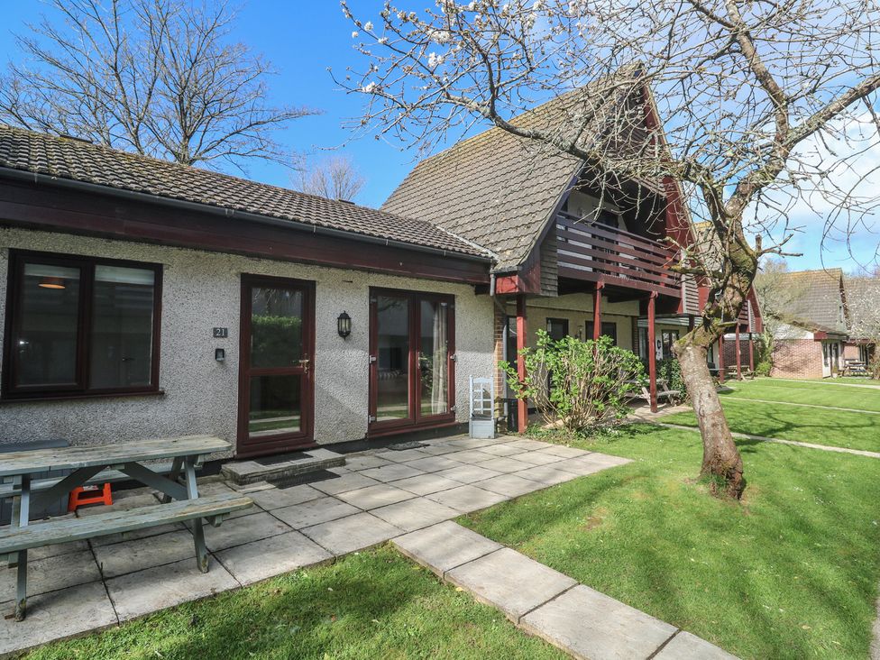 An outdoor view of a house with a picnic table and pathway at Tolroy Manor Holiday Park St Erth Praze near Hayle