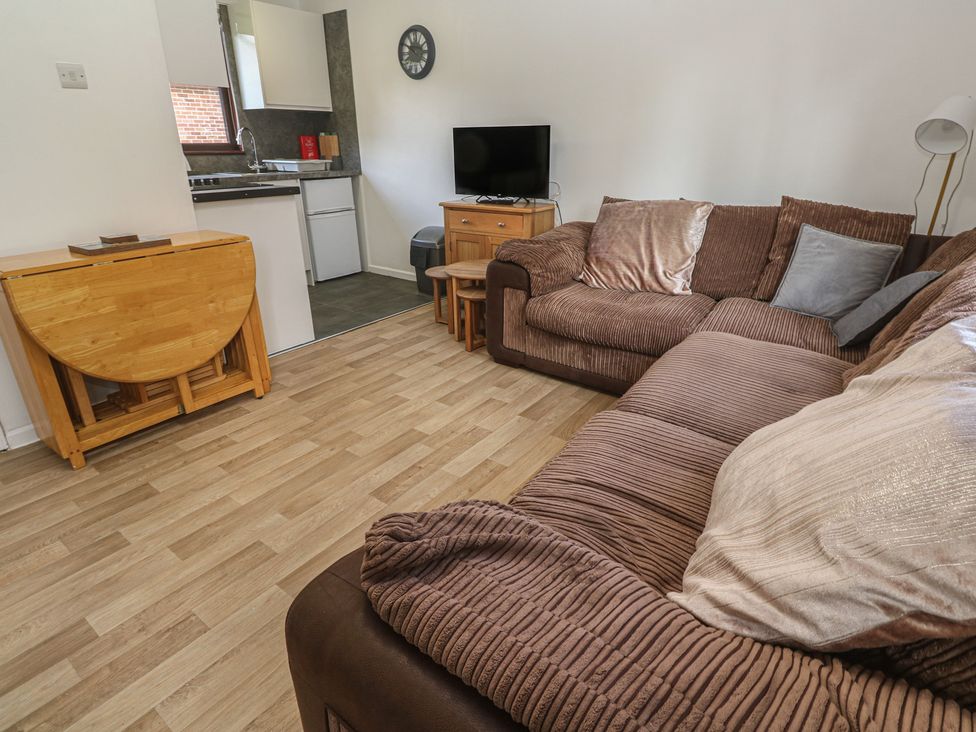 A living room with a sofa and TV at Tolroy Manor Holiday Park St Erth Praze near Hayle
