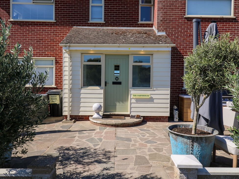 A doorway with a green door and a sign at The Farmhouse St. Osyth