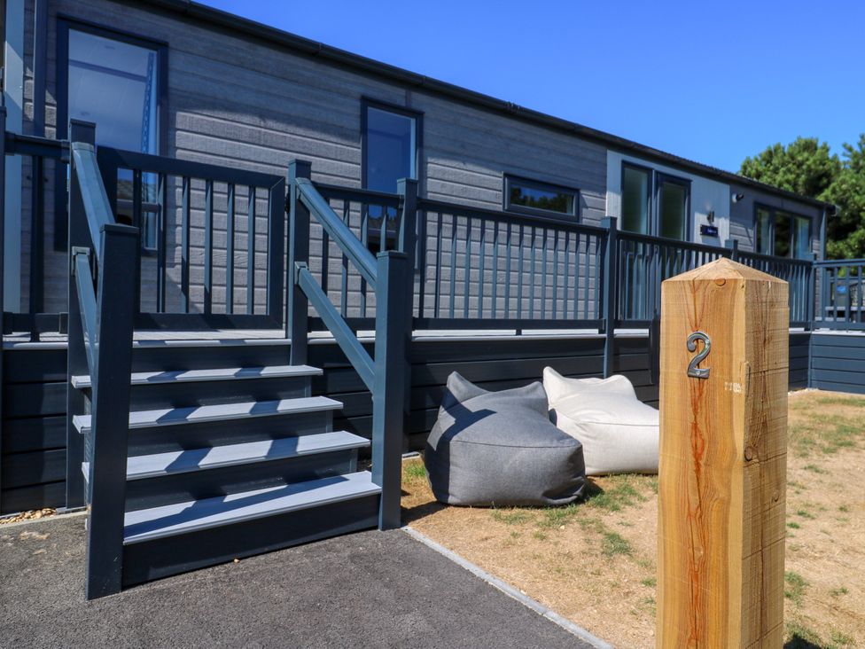 An outdoor area with stairs and bean bags at Lakewood Plot 2 St. Osyth