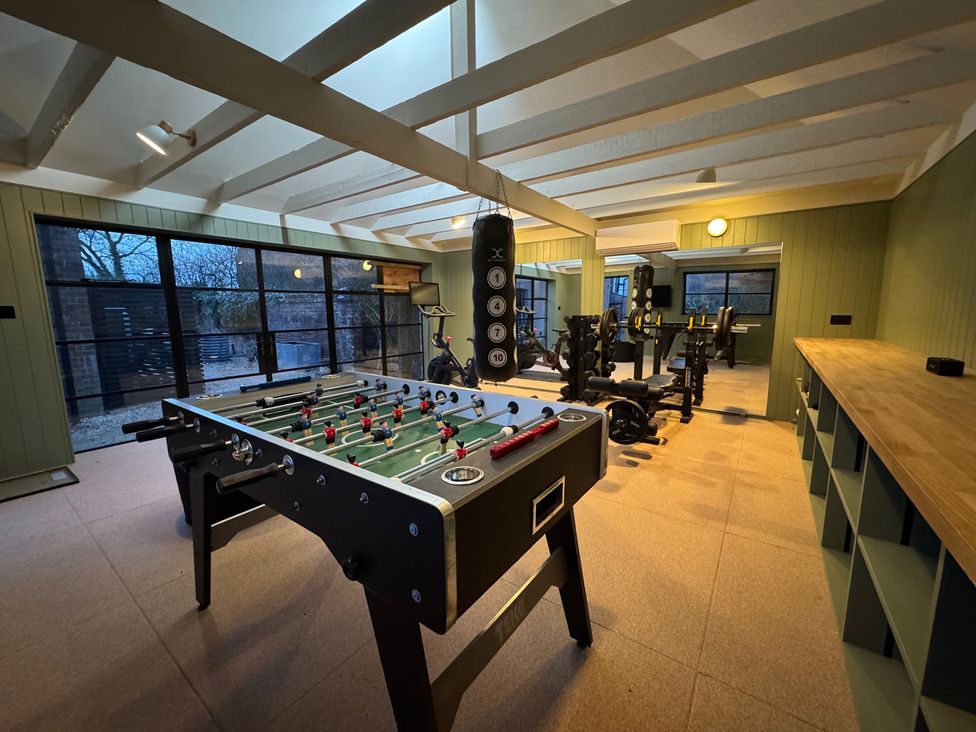 A game room with a foosball table and workout equipment at Oak Cottage Somerleyton