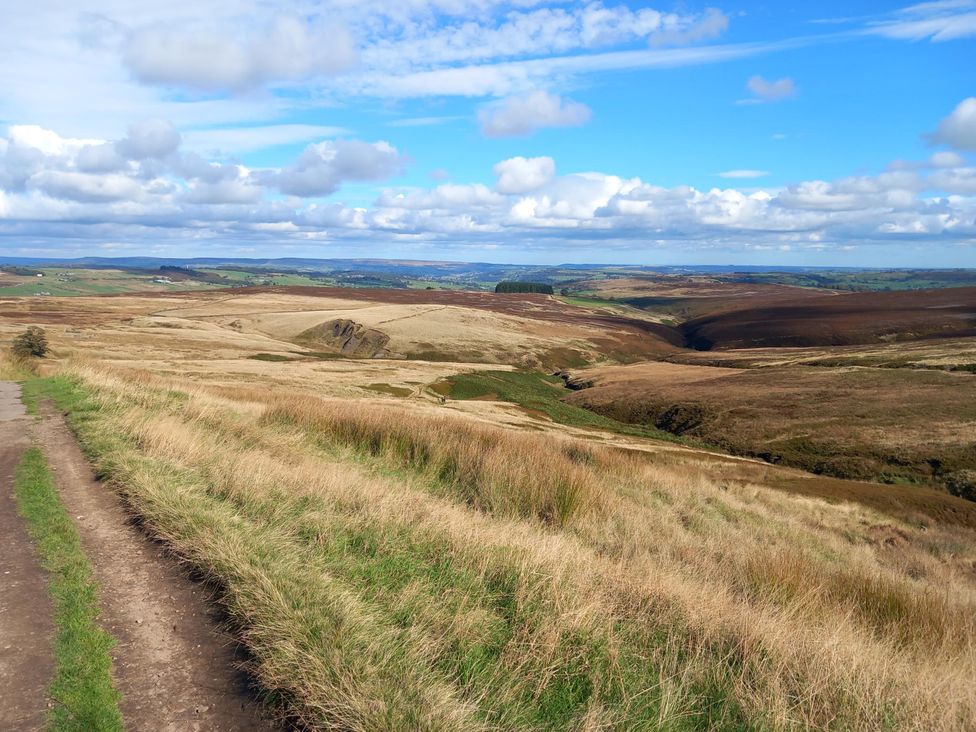 A landscape view showing hills and a path at Penny Cottage in Haworth