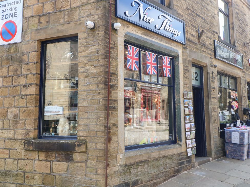 A shopfront with flags and postcards at Nice Things in Haworth
