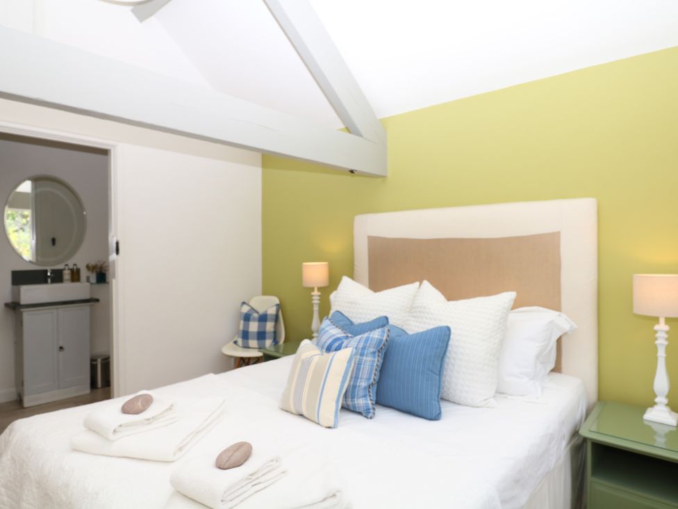 A bedroom with a bed and lamp at Apple Mill Venn Ottery near Sidmouth