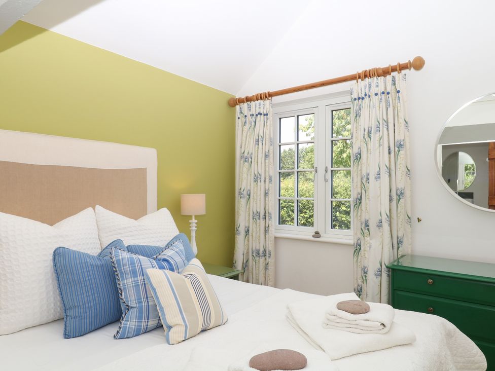 A bedroom with a bed and pillows at Apple Mill Venn Ottery near Sidmouth