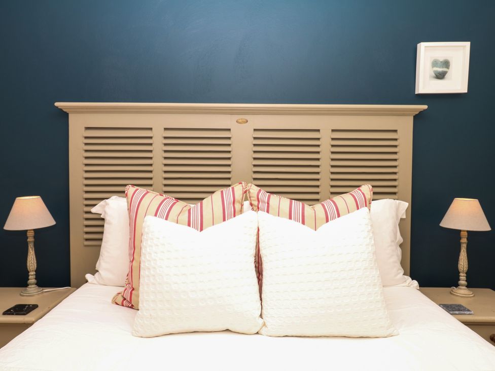 A bedroom with a bed and lamps at Apple Mill in Venn Ottery near Sidmouth