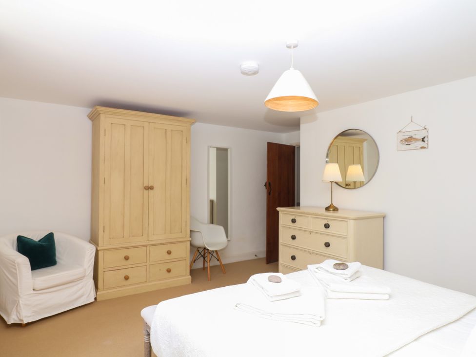 A bedroom with a dresser and wardrobe at Apple Mill in Venn Ottery near Sidmouth