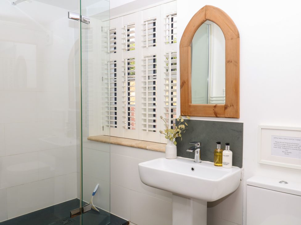 A bathroom with shower and washbasin at Apple Mill in Venn Ottery near Sidmouth