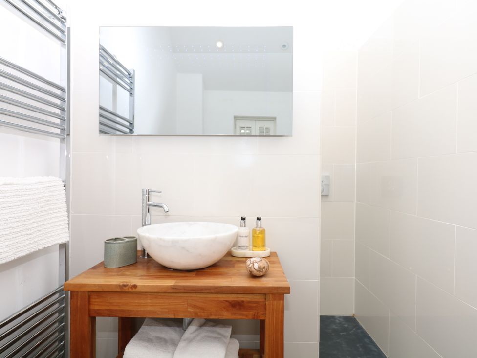 A bathroom with a sink and mirror at Apple Mill in Venn Ottery near Sidmouth