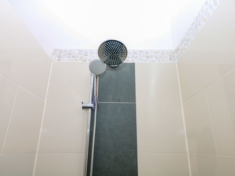 A shower with shower head and handheld fixture at Apple Mill Venn Ottery near Sidmouth