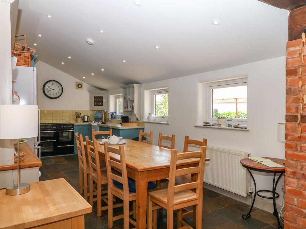 A kitchen with a dining table and chairs at Apple Mill in Venn Ottery near Sidmouth