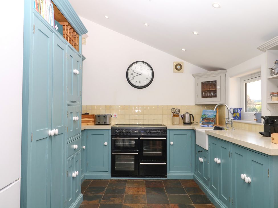 A kitchen with cupboards and appliances at Apple Mill in Venn Ottery near Sidmouth