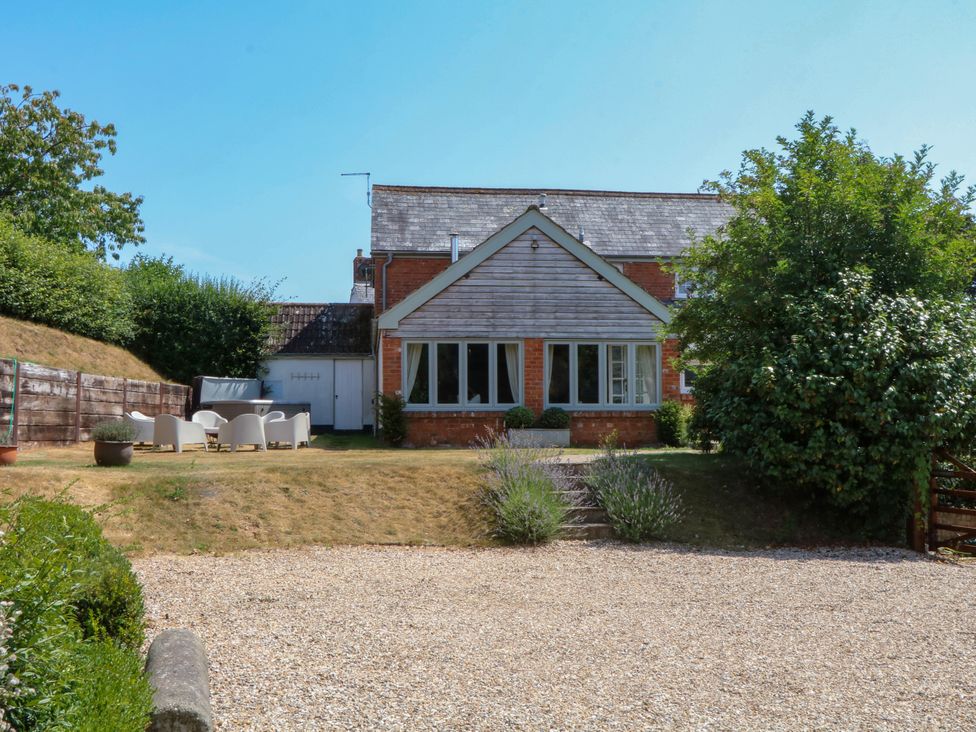 A house with patio furniture and a garden at Apple Mill Venn Ottery near Sidmouth